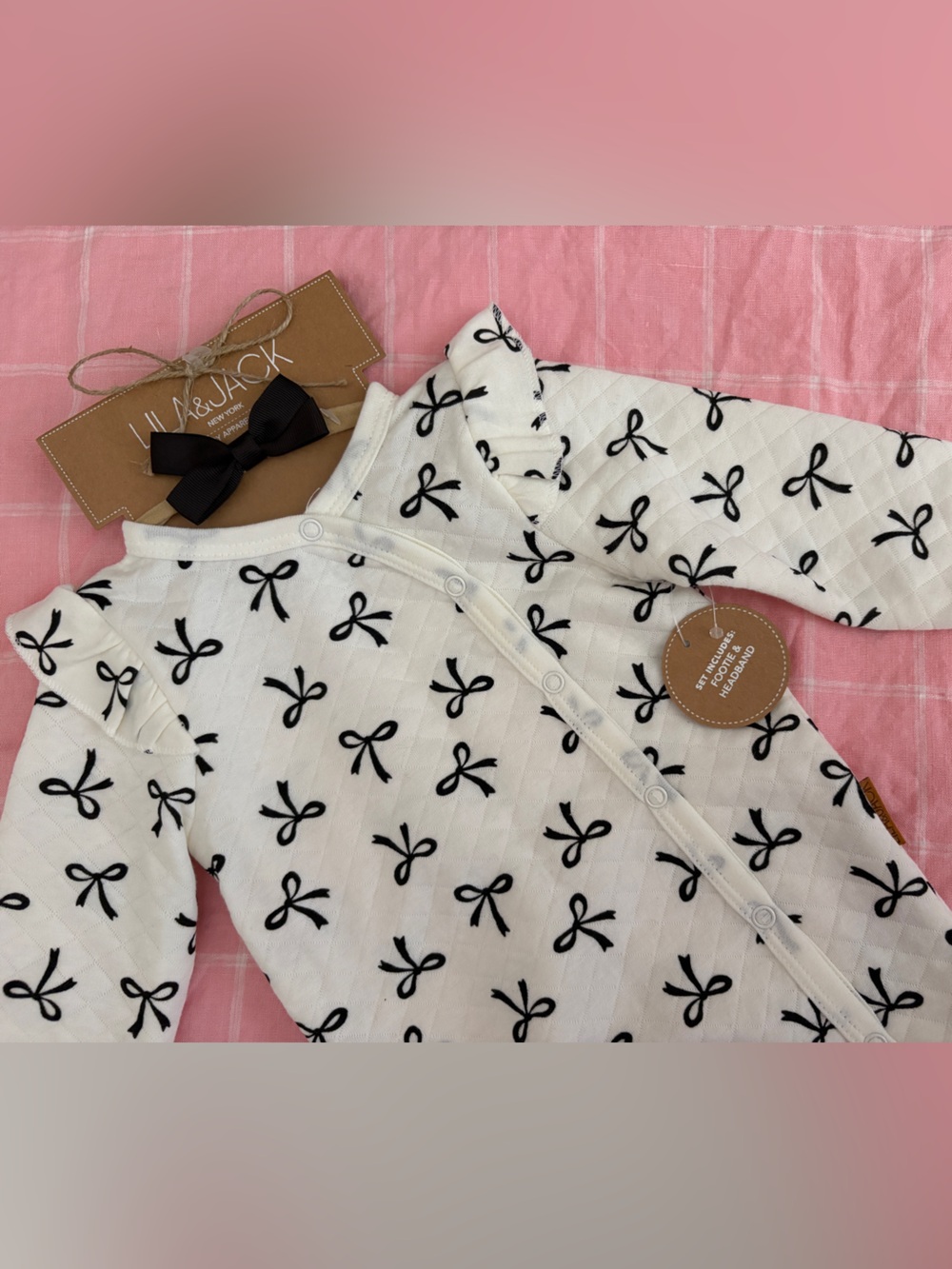Adorable cream and black bow print baby footie onesie with matching bow headband